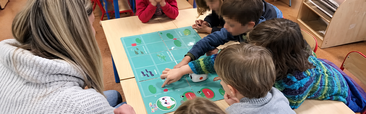 Children using a coding robot during a Back to School STEM Guide activity in the classroom