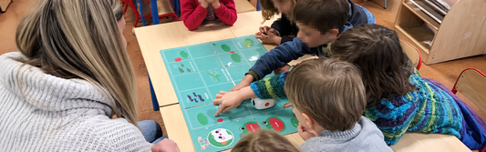 Children using a coding robot during a Back to School STEM Guide activity in the classroom