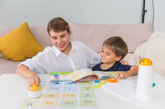 Adult and child using a screen-free coding robot for home with an activity guide